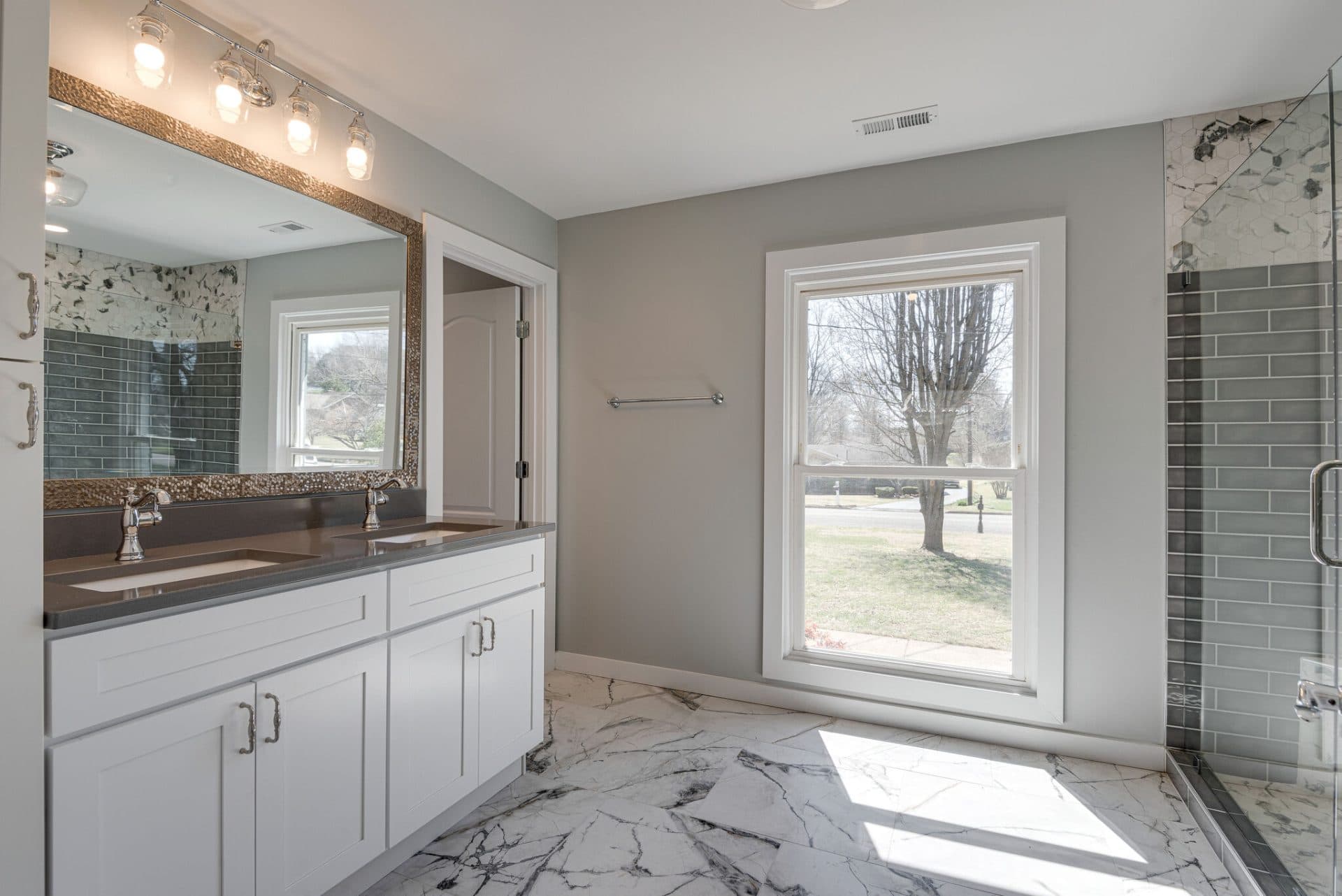 Kitchen renovation with white shaker cabinets and quartz countertops