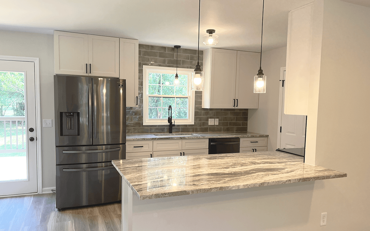 White shaker kitchen cabinets with modern finishes by Jessen Cabinets